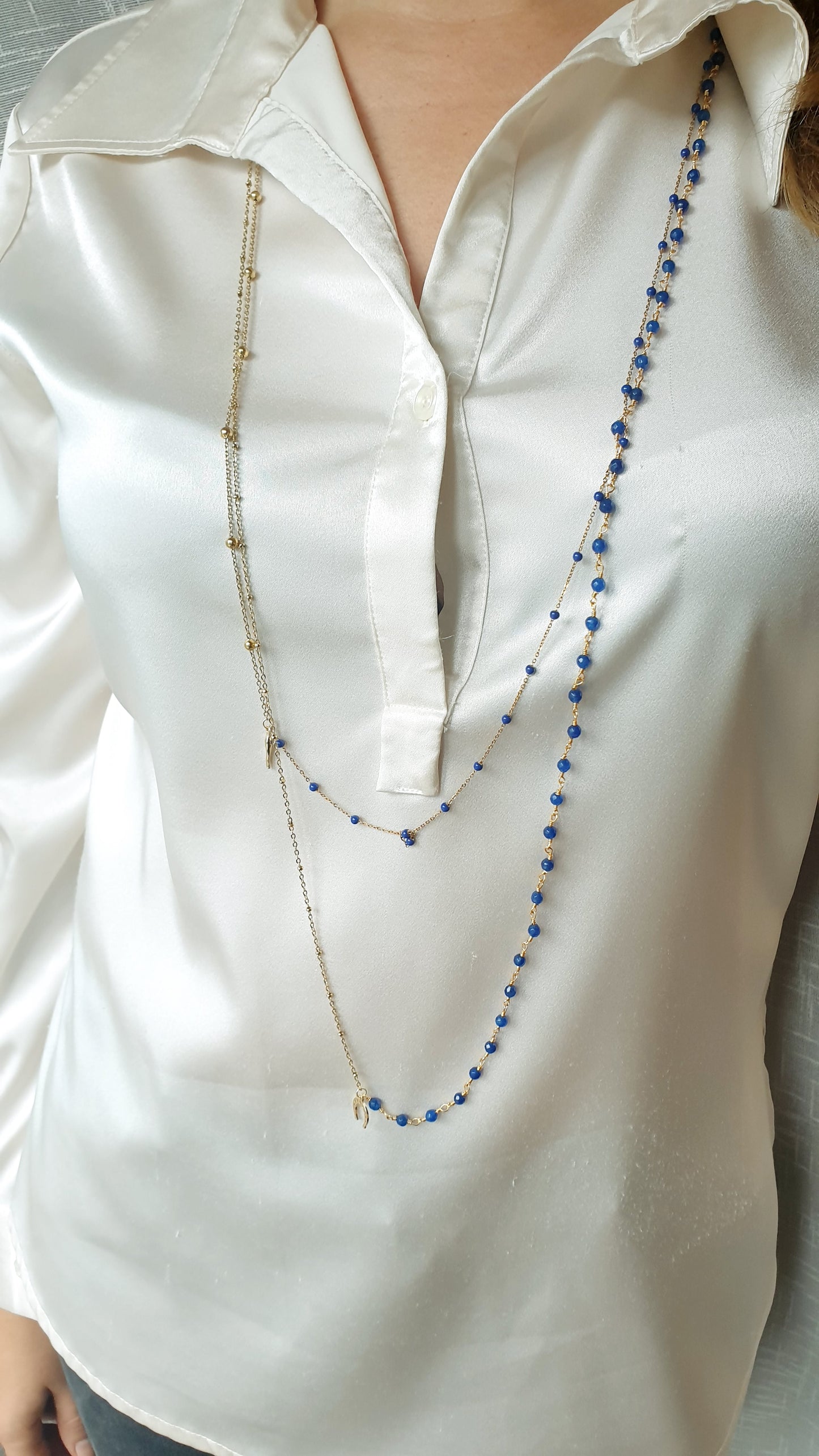 Very long metal necklace with charms.