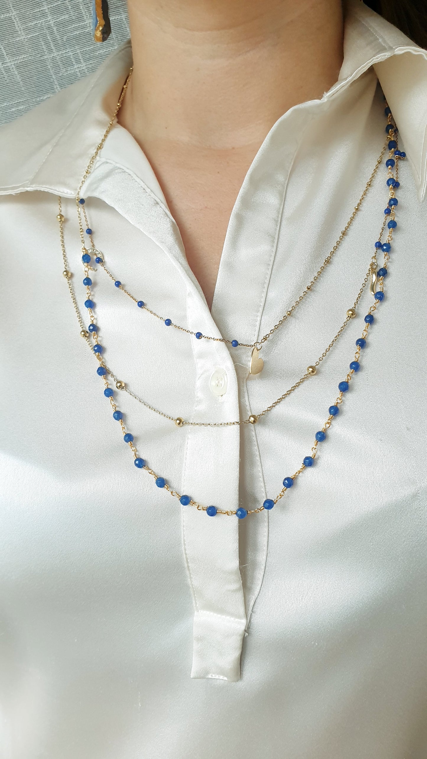 Very long metal necklace with charms.