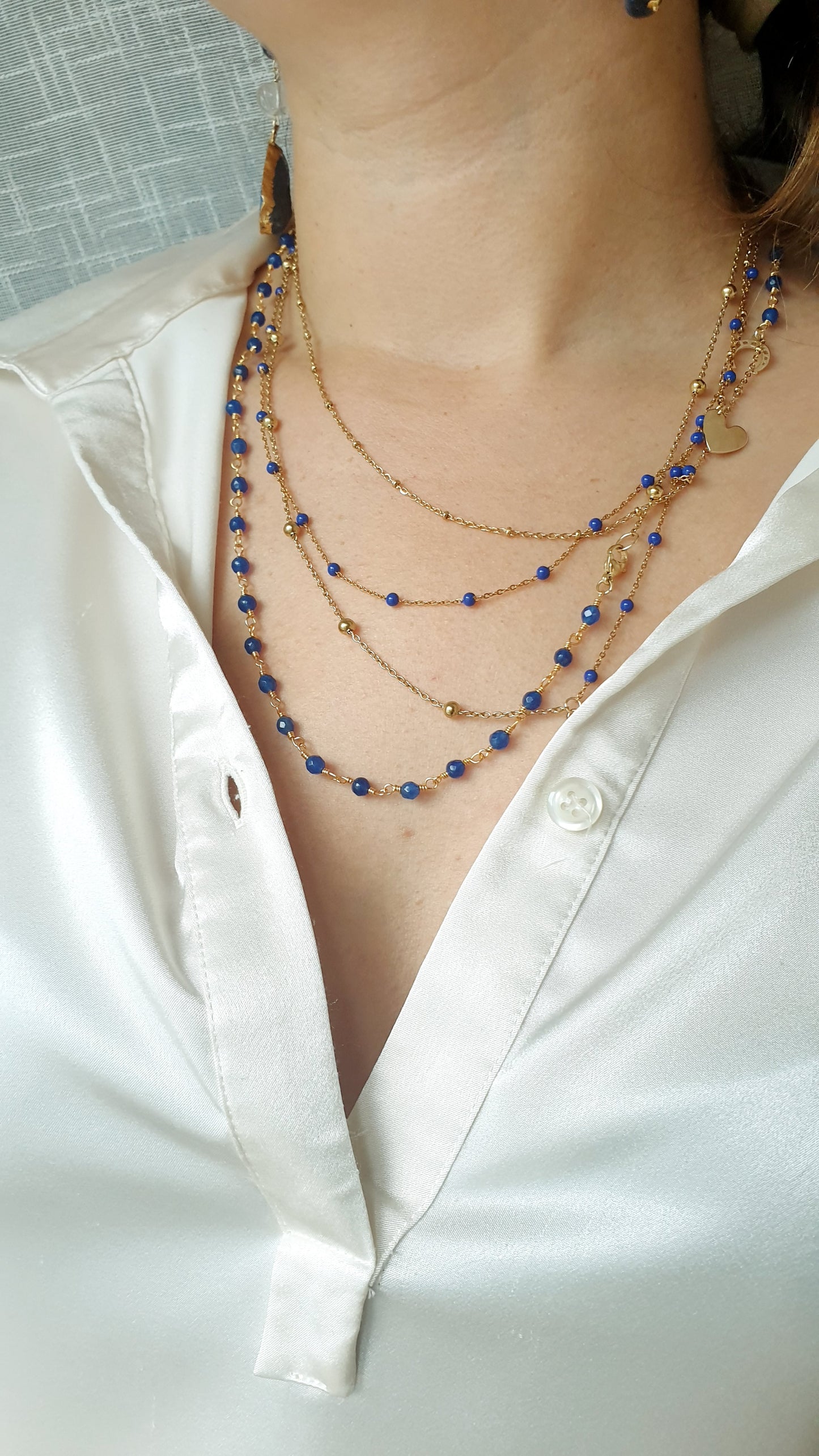Very long metal necklace with charms.