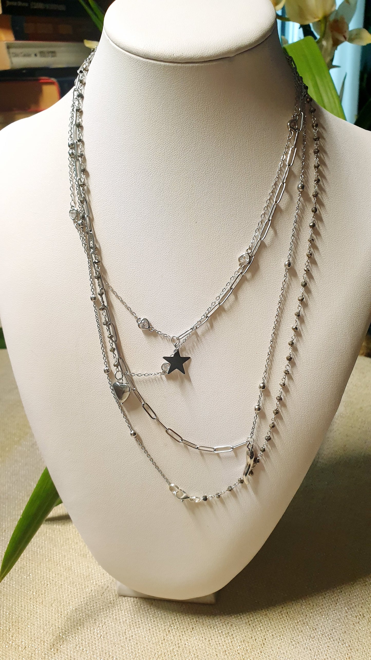 Very long metal necklace with charms.