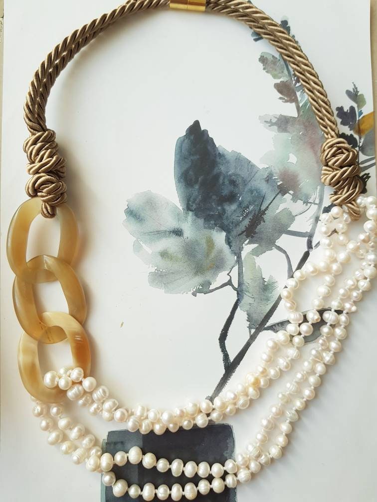 Horn, pearl, silk necklace.