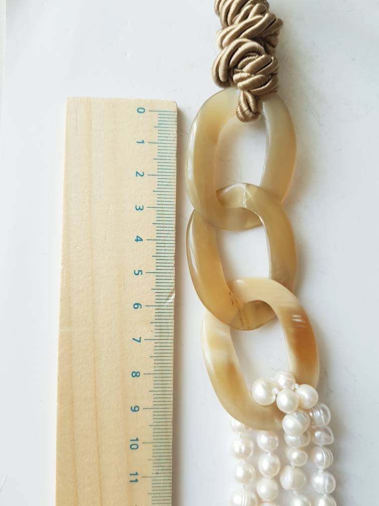 Horn, pearl, silk necklace.