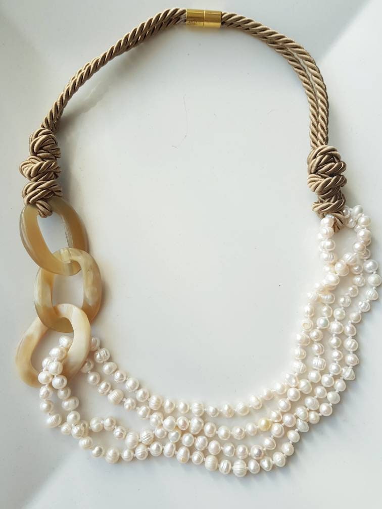 Horn, pearl, silk necklace.
