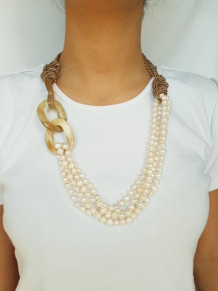 Horn, pearl, silk necklace.