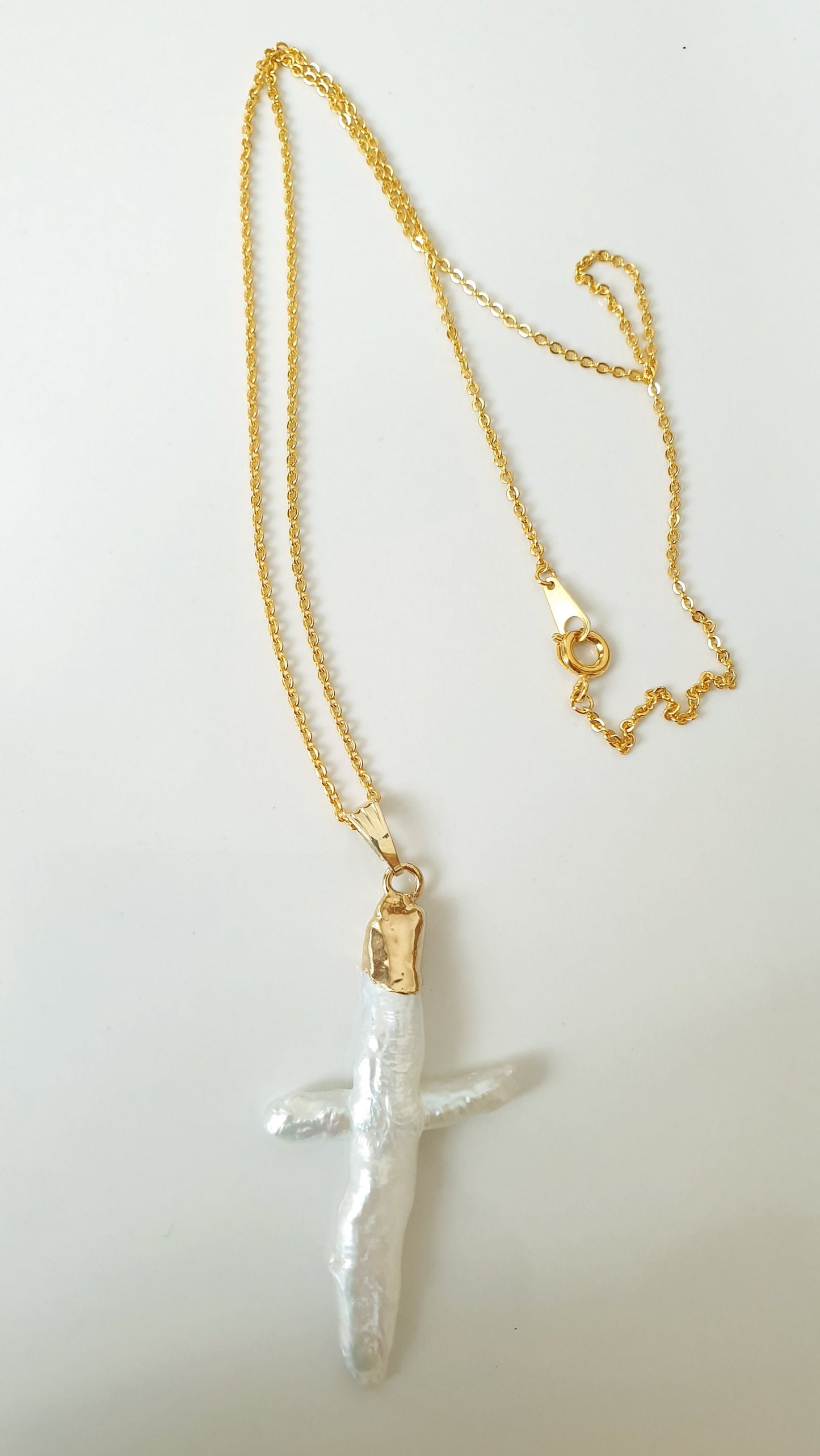 Gold plated choker with mother of pearl cross.