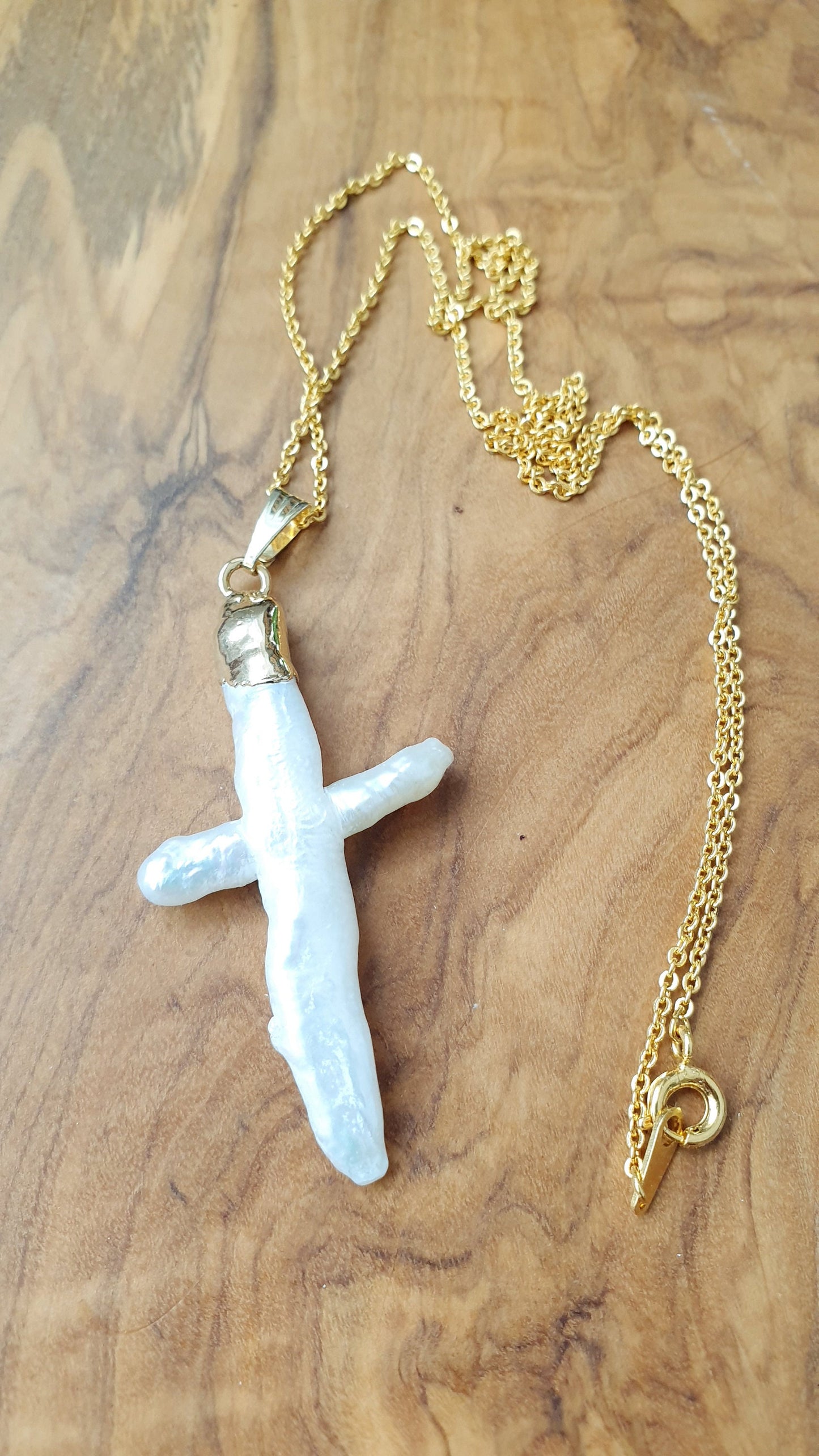 Gold plated choker with mother of pearl cross.