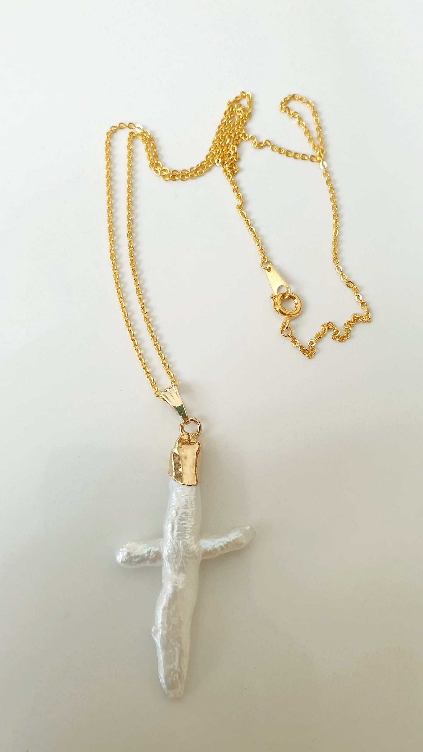 Gold plated choker with mother of pearl cross.