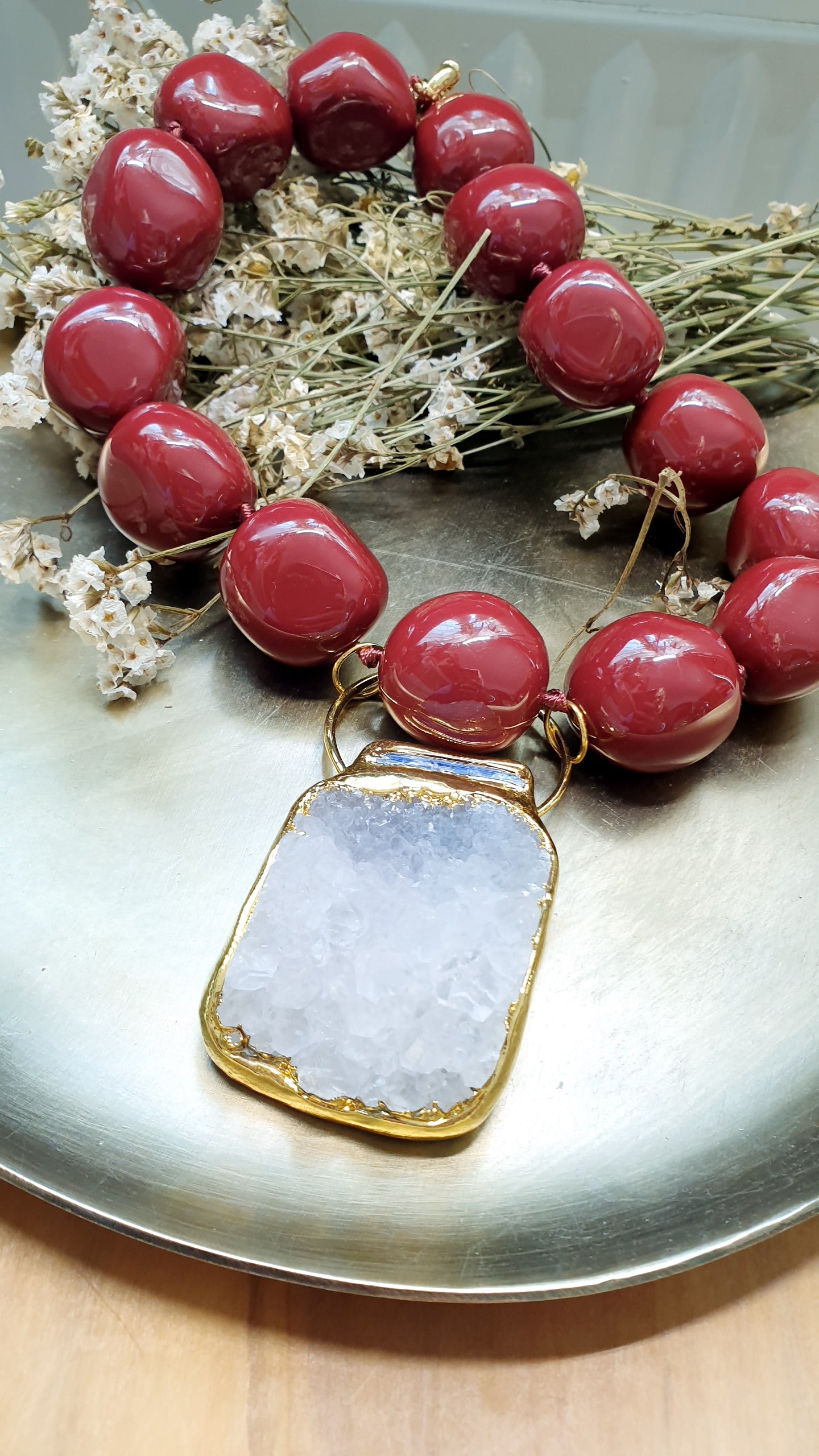Collana in resina borgogna con grande drusa di quarzo.
