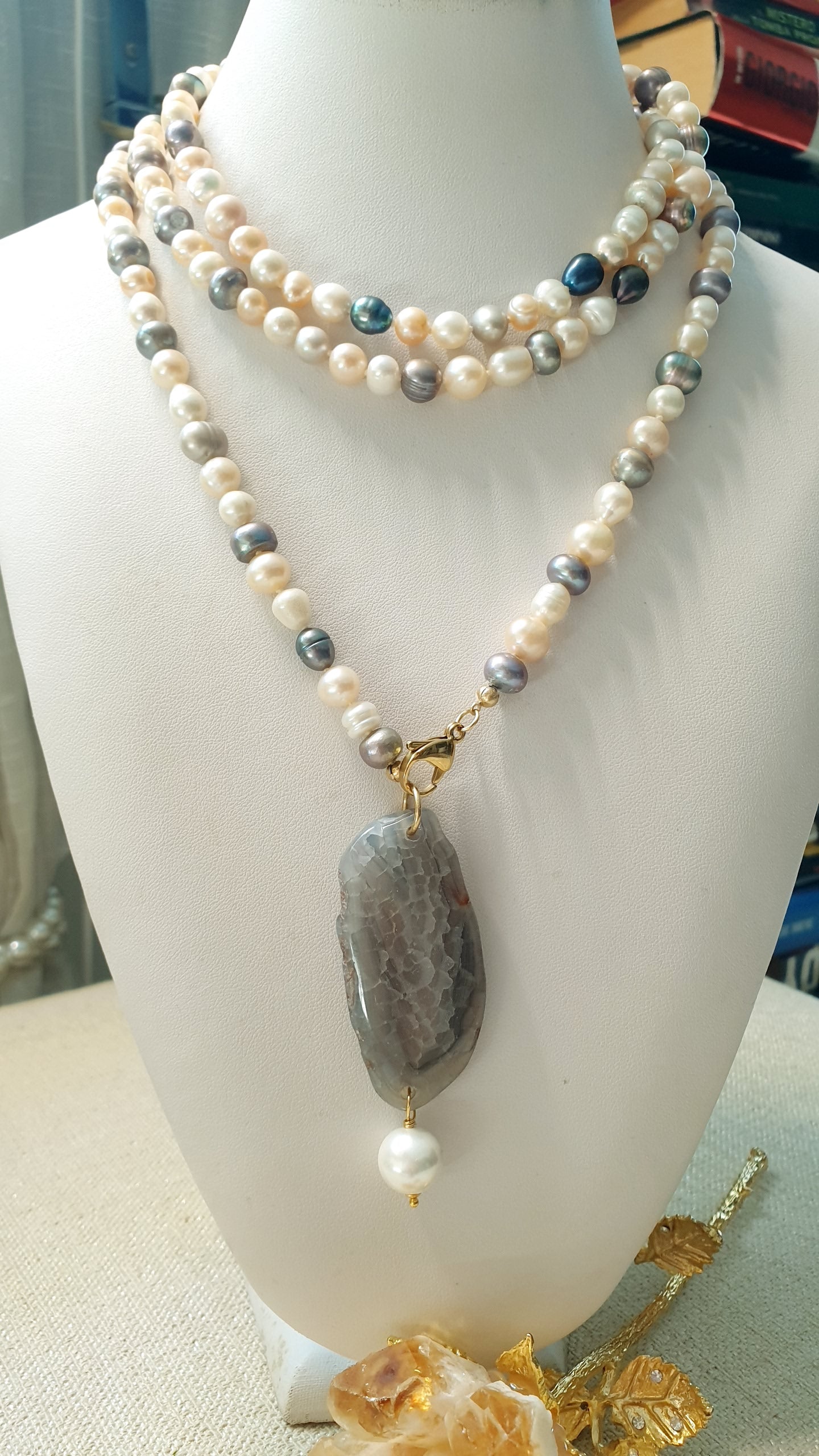 Lunga collana di perle di fiume con ciondolo di agata e perla.